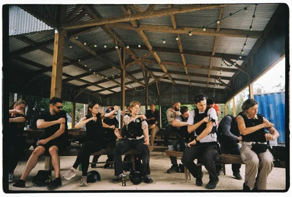 Trainees sit under a pavilion in Mafra, Portugal, practising tourniquets during Daily Humanity’s first HEAT with Drones course.
